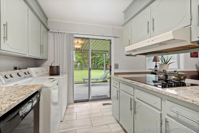 laundry room featuring washing machine and clothes dryer, ornamental molding, and light tile patterned flooring