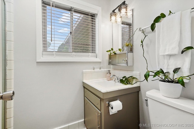 bathroom featuring toilet and vanity