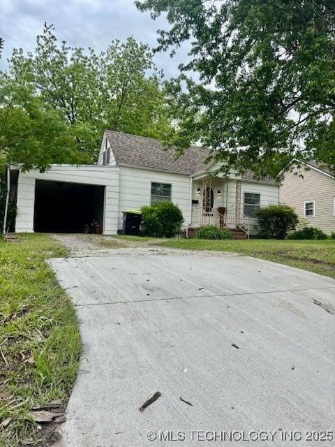 single story home featuring concrete driveway, an attached garage, and a front lawn