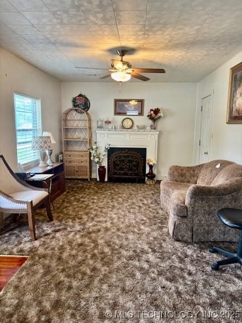 living room with a ceiling fan, a fireplace, and carpet floors