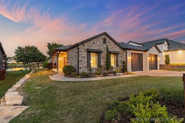12905 S 27th St, Bixby, OK 74008 - french country inspired facade featuring driveway, a front yard, stone siding, and an attached garage