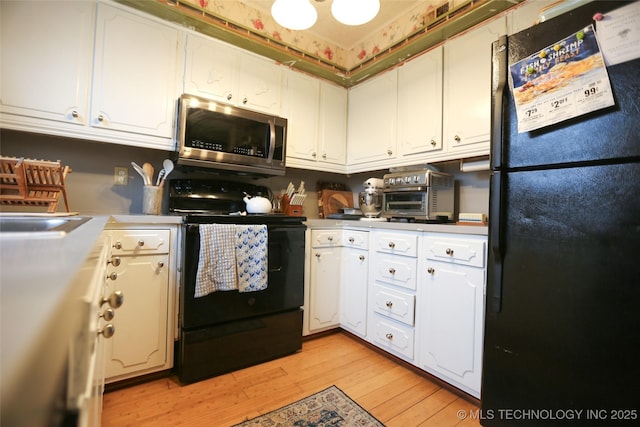 5518 E 46th St Unit 5518, Tulsa, OK 74135 - kitchen with black appliances, white cabinets, light wood-style flooring, and light countertops