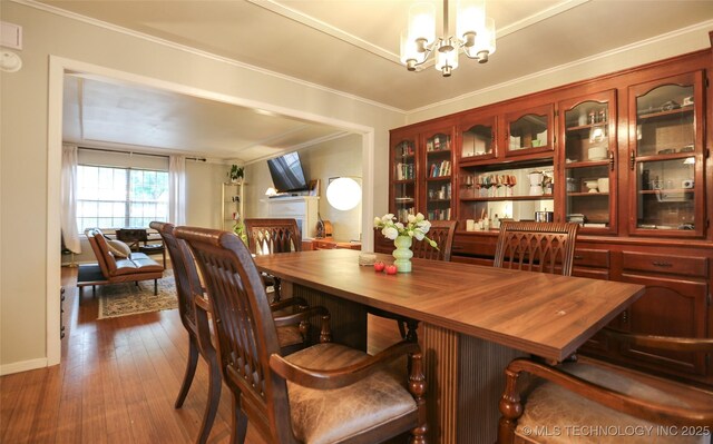 5518 E 46th St Unit 5518, Tulsa, OK 74135 - dining space with a chandelier, dark wood-style flooring, and crown molding
