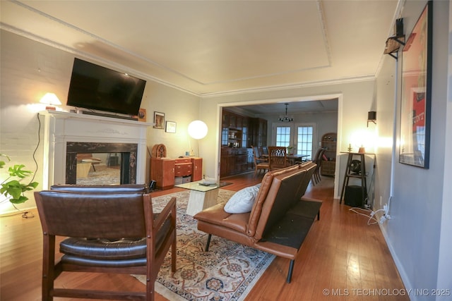 5518 E 46th St Unit 5518, Tulsa, OK 74135 - living room featuring wood finished floors, baseboards, a high end fireplace, and ornamental molding