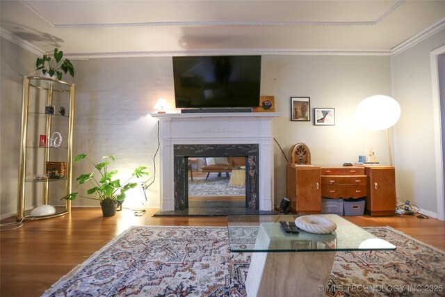 5518 E 46th St Unit 5518, Tulsa, OK 74135 - living room featuring wood finished floors, crown molding, a premium fireplace, and baseboards