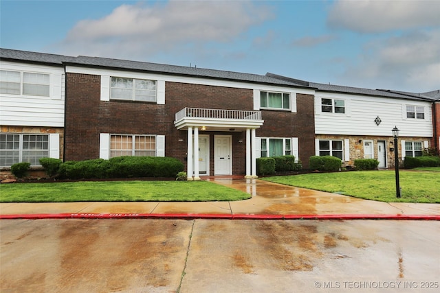 5518 E 46th St Unit 5518, Tulsa, OK 74135 - multi unit property featuring a balcony, a front yard, and brick siding