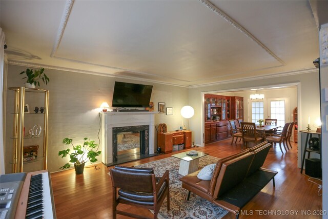 5518 E 46th St Unit 5518, Tulsa, OK 74135 - living room with a chandelier, a premium fireplace, wood finished floors, and ornamental molding