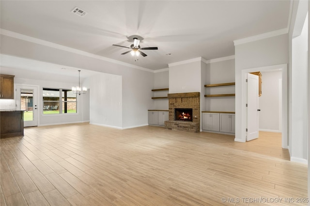 unfurnished living room featuring ceiling fan, a chandelier, baseboards, a fireplace, and ornamental molding