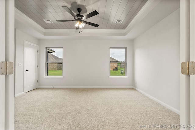 unfurnished bedroom with a raised ceiling, carpet floors, baseboards, wooden ceiling, and ceiling fan