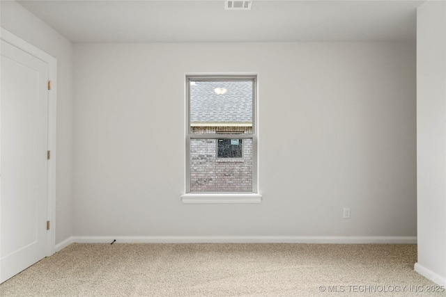 carpeted spare room with baseboards