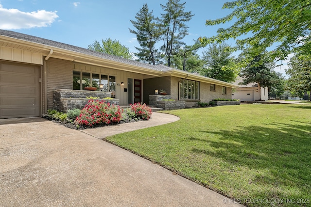 4031 S Birmingham Ave, Tulsa, OK 74105 - single story home featuring board and batten siding, a front lawn, brick siding, and concrete driveway