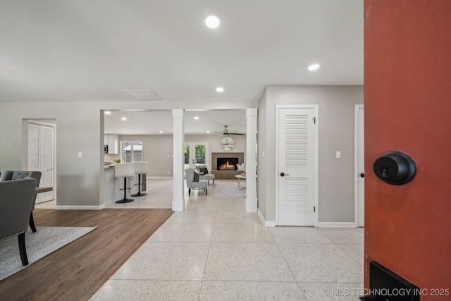 4031 S Birmingham Ave, Tulsa, OK 74105 - hall featuring baseboards, ornate columns, recessed lighting, and dark speckled floor