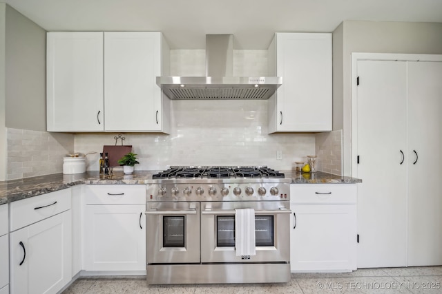 4031 S Birmingham Ave, Tulsa, OK 74105 - kitchen with double oven range, wall chimney range hood, white cabinetry, and dark stone countertops