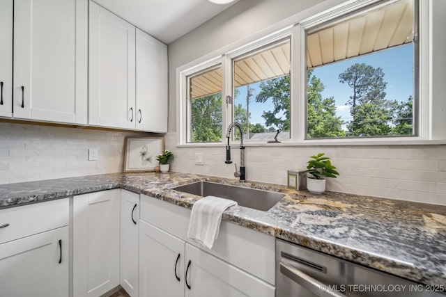 4031 S Birmingham Ave, Tulsa, OK 74105 - kitchen with a sink, stainless steel dishwasher, tasteful backsplash, and white cabinetry
