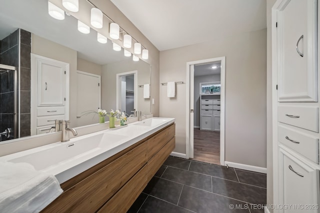 4031 S Birmingham Ave, Tulsa, OK 74105 - full bathroom with tile patterned flooring, double vanity, baseboards, and a spacious closet