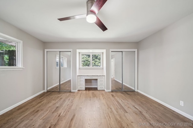4031 S Birmingham Ave, Tulsa, OK 74105 - unfurnished bedroom featuring multiple closets, multiple windows, light wood-type flooring, and baseboards