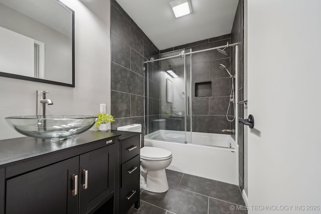 4031 S Birmingham Ave, Tulsa, OK 74105 - full bathroom featuring toilet, tile patterned flooring, shower / bath combination with glass door, and vanity