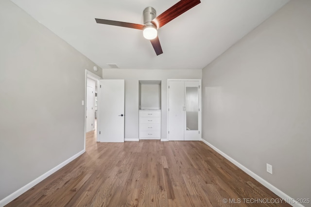4031 S Birmingham Ave, Tulsa, OK 74105 - unfurnished bedroom with baseboards, wood finished floors, and a ceiling fan