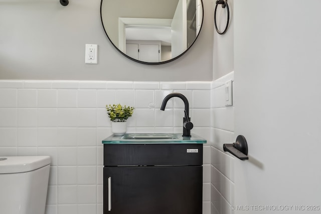 4031 S Birmingham Ave, Tulsa, OK 74105 - half bath featuring tile walls, wainscoting, vanity, and toilet