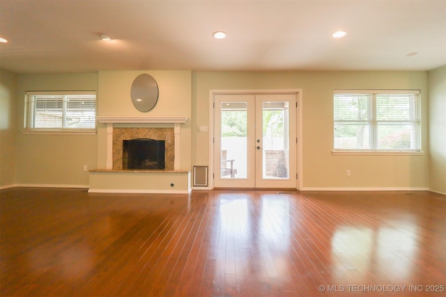 unfurnished living room with plenty of natural light, french doors, baseboards, and recessed lighting