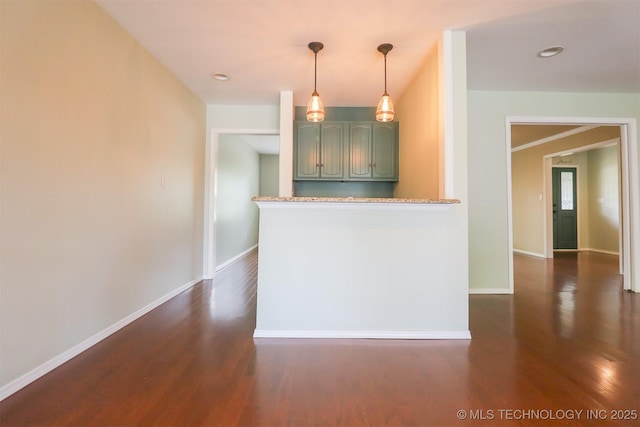 kitchen featuring green cabinetry, dark wood finished floors, baseboards, and recessed lighting