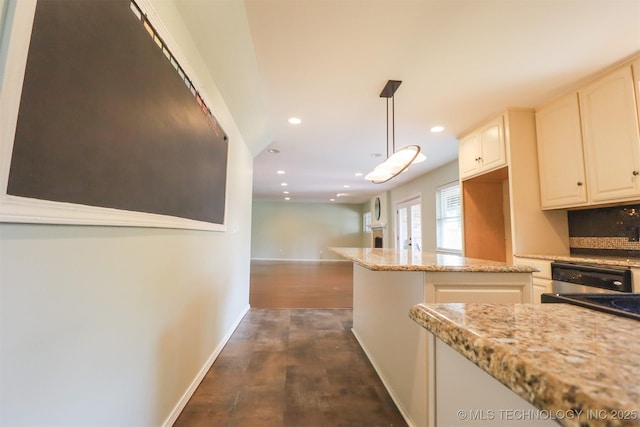 kitchen featuring recessed lighting, decorative light fixtures, dark wood-style floors, baseboards, and light stone counters