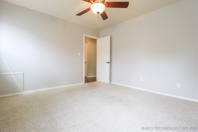 empty room with ceiling fan, baseboards, and carpet floors