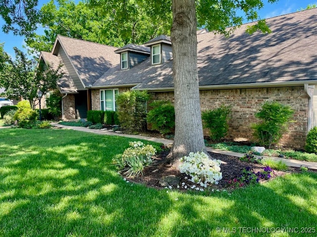 2995 E 56th Pl, Tulsa, OK 74105 - view of front of home with brick siding, a front yard, and roof with shingles