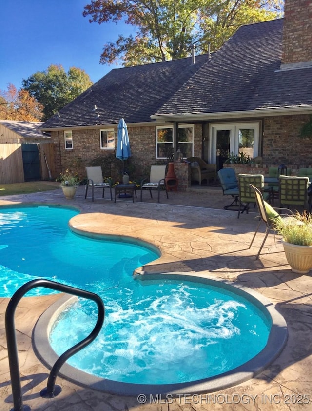 view of swimming pool with a patio