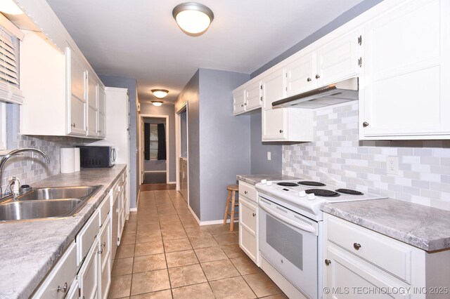 kitchen with electric stove, a sink, under cabinet range hood, stainless steel microwave, and white cabinetry