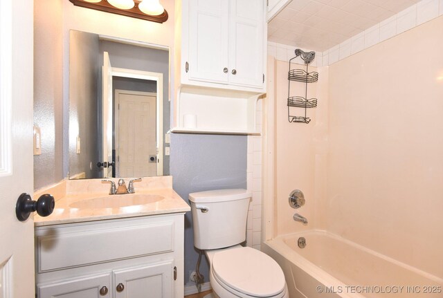 full bathroom featuring toilet, vanity, and bathing tub / shower combination