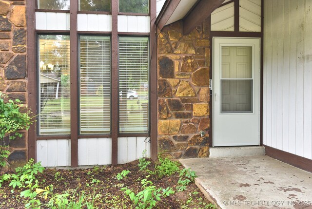 view of exterior entry featuring stone siding