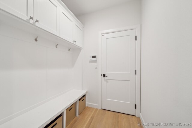 mudroom with light wood-style flooring and baseboards