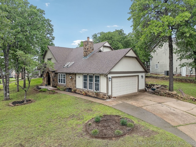 view of front of house featuring a shingled roof, driveway, an attached garage, stone siding, and a front yard