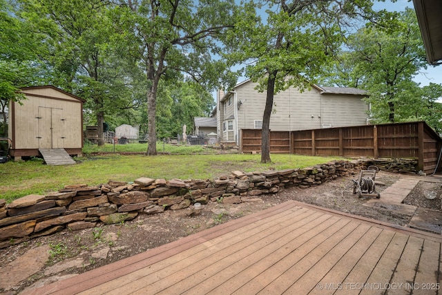 wooden deck with a storage unit and an outbuilding