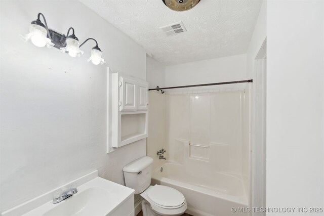120 Quail Dr, Pryor, OK 74361 - bathroom featuring a textured ceiling, toilet, bathing tub / shower combination, and a sink