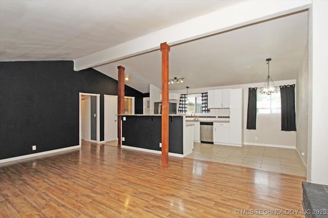 unfurnished living room with a chandelier, light wood-style flooring, a sink, and baseboards