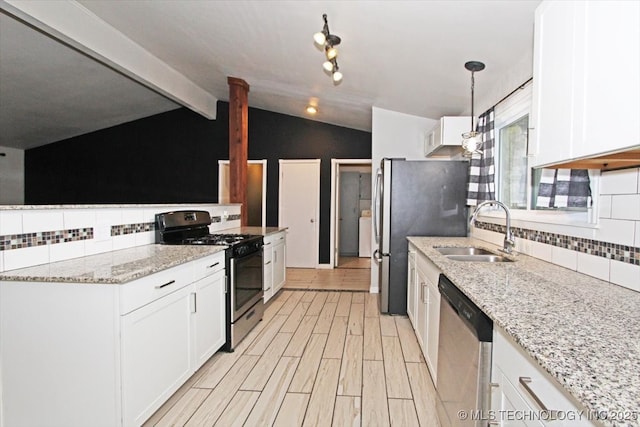 kitchen featuring appliances with stainless steel finishes, a sink, tasteful backsplash, and white cabinetry