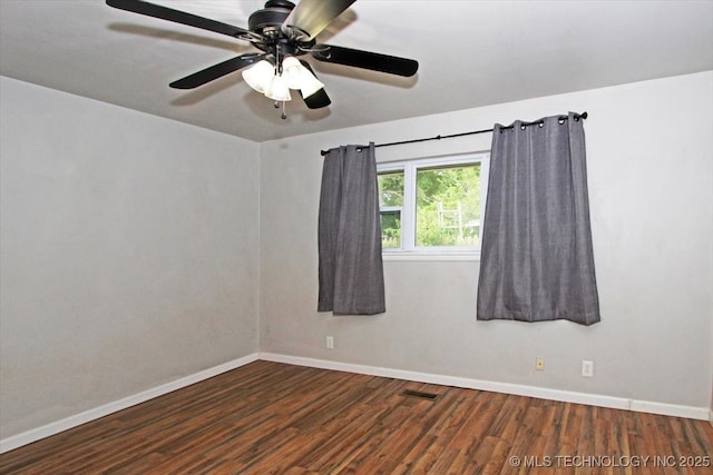 empty room with wood finished floors, baseboards, and ceiling fan