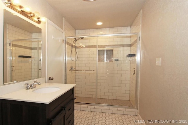 full bathroom with a shower stall, vanity, and recessed lighting