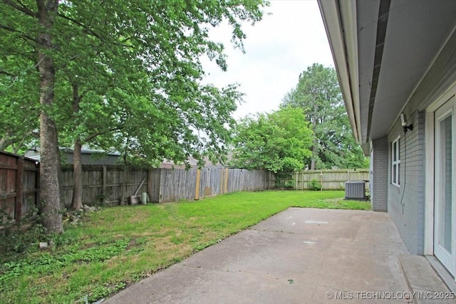 view of yard featuring central AC unit and a patio area
