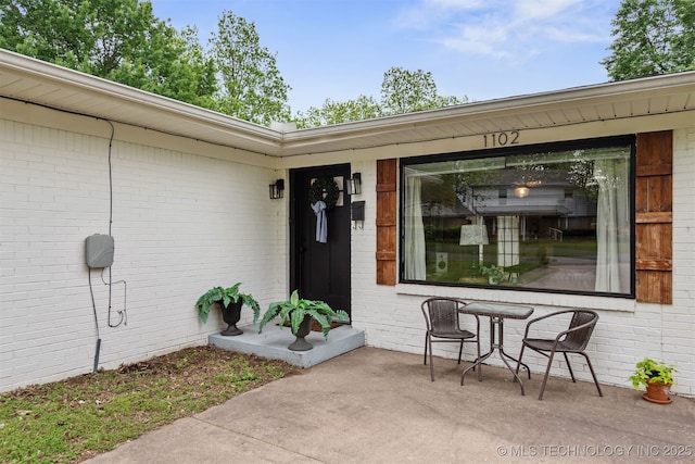 doorway to property with brick siding