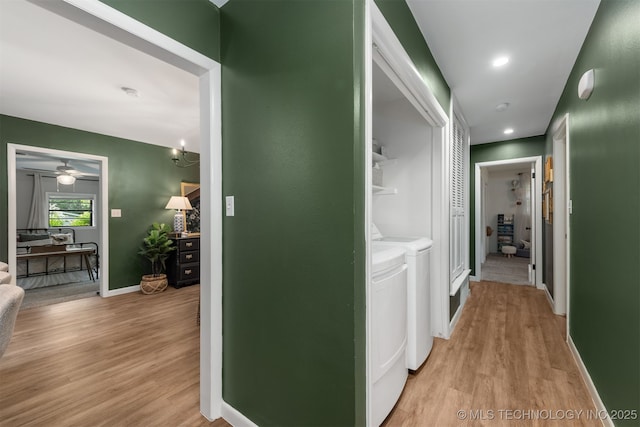 hall with washer and dryer, light wood finished floors, baseboards, and recessed lighting