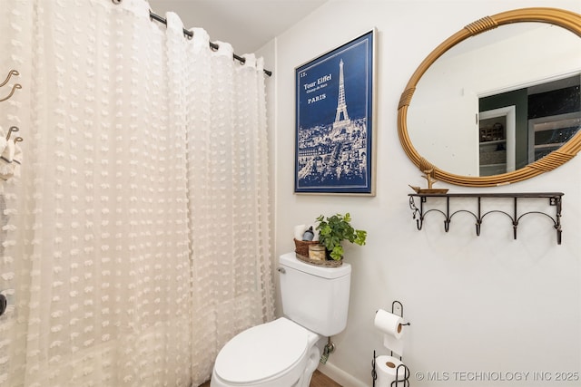 full bathroom with toilet and a shower with curtain