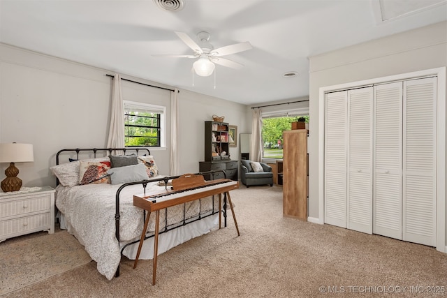 carpeted bedroom with a closet and ceiling fan