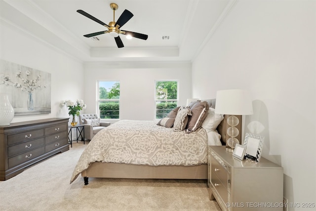bedroom with a raised ceiling, ornamental molding, carpet, and a ceiling fan