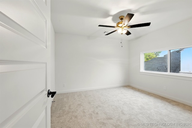 empty room with carpet floors, ceiling fan, and baseboards