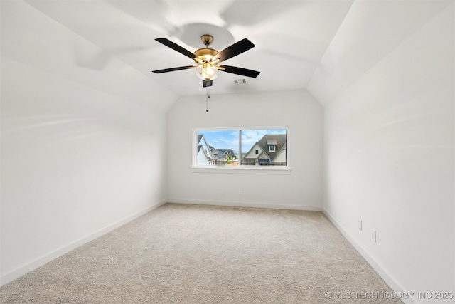 bonus room featuring light colored carpet, ceiling fan, vaulted ceiling, and baseboards