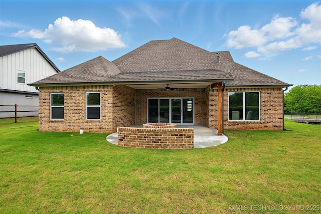 back of property with a patio area, a ceiling fan, brick siding, and a shingled roof