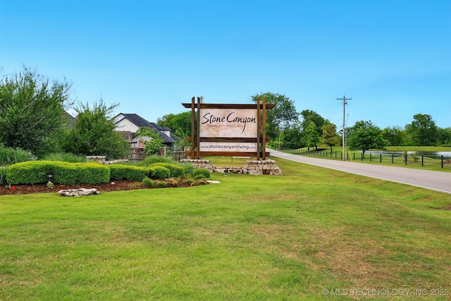 community / neighborhood sign with a lawn